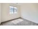 Bedroom features neutral walls, gray carpet, modern trim, and a window that fills the room with light at 12843 W Nevada Pl, Lakewood, CO 80228
