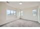 Bright bedroom features neutral walls and carpet, three windows for natural light, and baseboard trim at 12843 W Nevada Pl, Lakewood, CO 80228