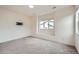 Bedroom features neutral walls, gray carpet, modern trim, and a window that fills the room with light at 12843 W Nevada Pl, Lakewood, CO 80228