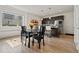 Bright dining area open to the kitchen includes modern lighting and an expansive picture window at 12843 W Nevada Pl, Lakewood, CO 80228