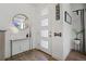 Bright foyer features wood flooring, a console table, round mirror, and unique decor at 12843 W Nevada Pl, Lakewood, CO 80228
