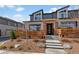 Modern townhome featuring a unique facade, landscaped front yard, and inviting entryway with stylish door and accents at 12843 W Nevada Pl, Lakewood, CO 80228