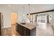 Kitchen island with dark cabinets, granite counter tops, stainless sink and pendant lighting at 12843 W Nevada Pl, Lakewood, CO 80228
