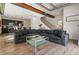 Spacious open concept living space features wood flooring, a large sectional sofa and kitchen access at 12843 W Nevada Pl, Lakewood, CO 80228