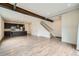 Open living space with a dark kitchen, wood floors and access to the stairway at 12843 W Nevada Pl, Lakewood, CO 80228