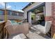 Relaxing outdoor patio with stylish lounge seating, fire pit, and sliding glass doors leading to the home's interior at 12843 W Nevada Pl, Lakewood, CO 80228