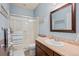 Bathroom featuring a tiled shower, single sink vanity, and blue walls at 6475 S Newcastle Way, Aurora, CO 80016