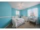 Bedroom with bright blue walls, and neutral carpet featuring desk, dresser, and bed at 6475 S Newcastle Way, Aurora, CO 80016