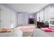Bedroom featuring two twin beds, pastel purple walls, and white trim at 6475 S Newcastle Way, Aurora, CO 80016