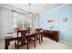 Beautiful dining room with large window, wooden furniture and blue accent wall at 6475 S Newcastle Way, Aurora, CO 80016