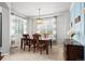 Elegant dining room with a modern chandelier, natural light, and neutral tones at 6475 S Newcastle Way, Aurora, CO 80016