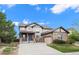 Charming two-story home with stone accents, an attached garage, and a manicured front lawn at 6475 S Newcastle Way, Aurora, CO 80016