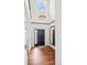 Bright foyer with hardwood floors, a grand light fixture, and a black front door at 6475 S Newcastle Way, Aurora, CO 80016