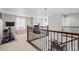 Upstairs hallway with views to workout area, and a dining area with decorative wood and iron railing at 6475 S Newcastle Way, Aurora, CO 80016