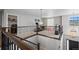 Upstairs hallway with views to workout area, laundry and foyer with decorative wood and iron railing at 6475 S Newcastle Way, Aurora, CO 80016