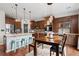 Well-lit kitchen with stainless steel appliances, an island with barstool seating, and a breakfast nook at 6475 S Newcastle Way, Aurora, CO 80016