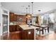Modern kitchen featuring stainless appliances, center island, and adjacent dining area with natural light at 6475 S Newcastle Way, Aurora, CO 80016