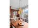 Charming breakfast nook with decorative lighting, wood table, and view to the backyard at 6475 S Newcastle Way, Aurora, CO 80016