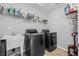 Laundry room equipped with washer, dryer, utility sink and shelving for cleaning products at 6475 S Newcastle Way, Aurora, CO 80016