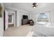Bright main bedroom with a large TV on a chest of drawers, and a seating area at 6475 S Newcastle Way, Aurora, CO 80016