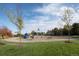 Community playground featuring a variety of slides, swings, and climbing structures on a landscaped lawn at 6475 S Newcastle Way, Aurora, CO 80016