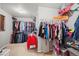 Walk-in closet with metal storage shelves and racks for clothing and personal items at 6475 S Newcastle Way, Aurora, CO 80016