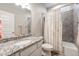 Stylish bathroom with granite countertop, modern fixtures, and tiled shower at 2187 Pineywoods St, Mead, CO 80542