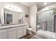 Beautiful bathroom featuring a walk-in shower and granite vanity top at 2187 Pineywoods St, Mead, CO 80542