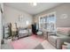 Cozy Bedroom with a crib, rocking chair, and soft pink accents at 2187 Pineywoods St, Mead, CO 80542