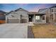 Charming exterior features a welcoming front porch, well-maintained lawn, and a three car garage at 2187 Pineywoods St, Mead, CO 80542