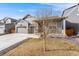 Charming exterior features a welcoming front porch, well-maintained lawn, and a three car garage at 2187 Pineywoods St, Mead, CO 80542