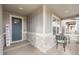 Covered front porch features a table and chairs and decorative stone at 2187 Pineywoods St, Mead, CO 80542