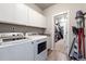 Well-equipped laundry room with washer, dryer, and ample storage cabinets at 2187 Pineywoods St, Mead, CO 80542