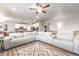 Open-concept living room featuring a large sectional couch, rug, and hardwood floors at 2187 Pineywoods St, Mead, CO 80542