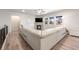 Spacious living room with hardwood floors, fireplace, and large sectional couch at 2187 Pineywoods St, Mead, CO 80542