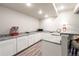 Basement wet bar boasts granite counters, white cabinets, and a microwave at 2187 Pineywoods St, Mead, CO 80542
