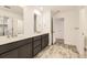 Bathroom with double vanity, gray cabinets, and large mirrors at 39816 Floyd St, Elizabeth, CO 80107