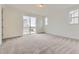Bright bedroom with plush carpeting, slider doors, and large windows for plenty of natural light at 39816 Floyd St, Elizabeth, CO 80107