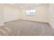 A spacious bedroom with plush gray carpeting and a large window offering natural light at 39816 Floyd St, Elizabeth, CO 80107