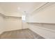 Walk-in closet featuring carpet flooring, white walls, and metal shelving at 39816 Floyd St, Elizabeth, CO 80107