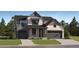 Beautiful two-story home featuring a covered porch, white siding, and a two-car garage on a lush landscaped lot at 39816 Floyd St, Elizabeth, CO 80107