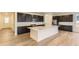 Spacious kitchen featuring a large center island, stainless steel appliances, and dark cabinetry at 39816 Floyd St, Elizabeth, CO 80107