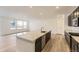 Modern kitchen with large island, stainless appliances, sleek cabinetry, and hardwood floors at 39816 Floyd St, Elizabeth, CO 80107