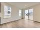 Living room with hardwood floors, bright natural light, and sliding glass doors to the backyard at 39816 Floyd St, Elizabeth, CO 80107