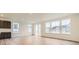 Bright living room with hardwood floors, large windows, and sliding glass doors to the backyard at 39816 Floyd St, Elizabeth, CO 80107