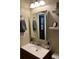 Well-lit powder room featuring a modern vanity with a mirrored cabinet and storage shelves at 1829 S Lee St # C, Lakewood, CO 80232