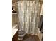 Bathroom featuring a patterned shower curtain and a convenient storage shelf at 1829 S Lee St # C, Lakewood, CO 80232