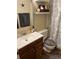 Bathroom featuring a stylish vanity with a dark wood finish and a framed mirror adding depth and character at 1829 S Lee St # C, Lakewood, CO 80232