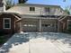 Home exterior featuring a two-car garage and classic brick and siding design at 1829 S Lee St # C, Lakewood, CO 80232