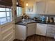 Bright kitchen featuring stainless steel sink and appliances, with view of door at 1829 S Lee St # C, Lakewood, CO 80232